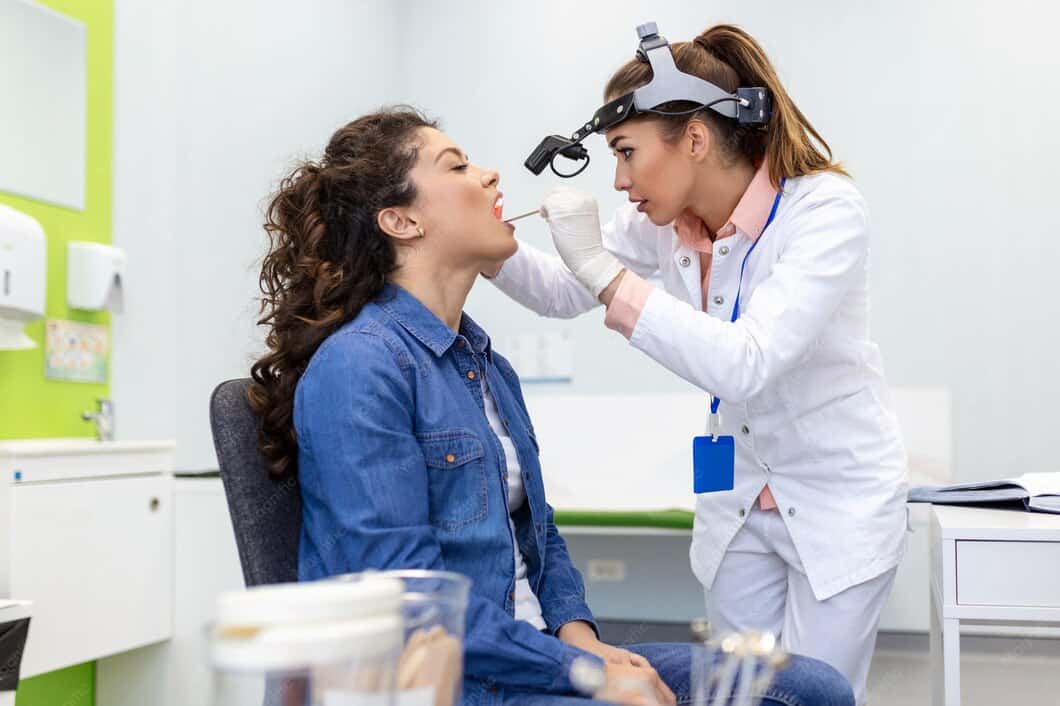 Doctor examining patient during rhinoplasty consultation at VJ Clinics.